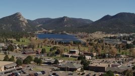 5.7K aerial stock footage of Lake Estes, by golf course and green mountains while descending in Estes Park, Colorado Aerial Stock Footage | DX0001_001982