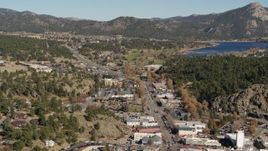 5.7K aerial stock footage flyby shops lining road through Estes Park, Colorado lake and mountains in distance Aerial Stock Footage | DX0001_001998
