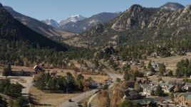 5.7K aerial stock footage of rural homes near rugged mountains in Estes Park, Colorado Aerial Stock Footage | DX0001_002000