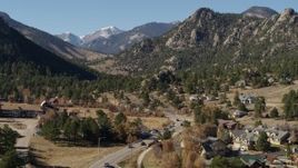5.7K aerial stock footage flyby rural homes near rugged mountains in Estes Park, Colorado seen while descending Aerial Stock Footage | DX0001_002003