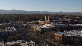 5.7K aerial stock footage reverse view of office buildings, shops, parking garage in Fort Collins, Colorado Aerial Stock Footage | DX0001_002036