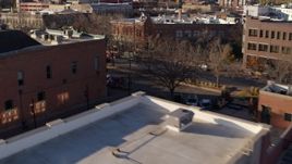 5.7K aerial stock footage of passing brick office buildings and street level shop in Fort Collins, Colorado Aerial Stock Footage | DX0001_002042