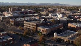 5.7K aerial stock footage of passing brick office buildings and street level shops in Fort Collins, Colorado Aerial Stock Footage | DX0001_002045