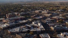 5.7K aerial stock footage fly away from and flyby shops and office buildings by wide streets in Fort Collins, Colorado Aerial Stock Footage | DX0001_002055