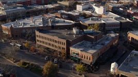 5.7K aerial stock footage orbit a shop with green awning and brick office building in Fort Collins, Colorado Aerial Stock Footage | DX0001_002057