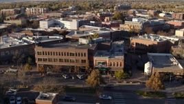 5.7K aerial stock footage passing a shop with green awning and brick office building in Fort Collins, Colorado Aerial Stock Footage | DX0001_002058