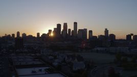 5.7K aerial stock footage of the rising sun behind the city's skyline in Downtown Minneapolis, Minnesota Aerial Stock Footage | DX0001_002061