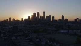 5.7K aerial stock footage of a view of the rising sun behind the city's skyline in Downtown Minneapolis, Minnesota Aerial Stock Footage | DX0001_002062