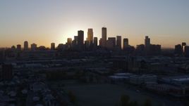 5.7K aerial stock footage approach the city's skyline as the sun rises and ascend in Downtown Minneapolis, Minnesota Aerial Stock Footage | DX0001_002066