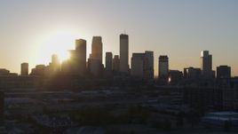 5.7K aerial stock footage focus on city skyline at sunrise during slow flyby and ascent in Downtown Minneapolis, Minnesota Aerial Stock Footage | DX0001_002075