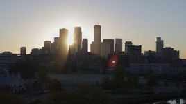 5.7K aerial stock footage of the rising sun behind the city skyline seen during ascent in Downtown Minneapolis, Minnesota Aerial Stock Footage | DX0001_002080