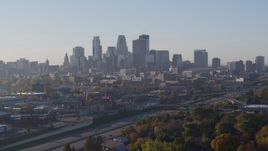 5.7K aerial stock footage ascend from park to reveal the city's downtown skyline at sunrise in Downtown Minneapolis, Minnesota Aerial Stock Footage | DX0001_002100