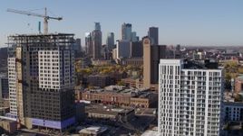5.7K aerial stock footage of flyby apartment building at sunrise with skyline in background in Downtown Minneapolis, Minnesota Aerial Stock Footage | DX0001_002118
