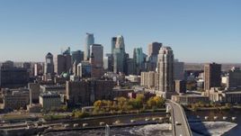 5.7K aerial stock footage slowly flying by the skyline, seen from a bridge spanning the river in Downtown Minneapolis, Minnesota Aerial Stock Footage | DX0001_002136