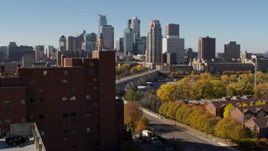5.7K aerial stock footage fly over building to approach skyline and a bridge spanning the river in Downtown Minneapolis, Minnesota Aerial Stock Footage | DX0001_002141