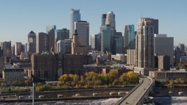 5.7K aerial stock footage flying by the skyline on the other side of the Mississippi River, Downtown Minneapolis, Minnesota Aerial Stock Footage | DX0001_002149