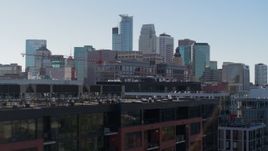 5.7K aerial stock footage descend by office building and city's skyline, reveal apartment building, Downtown Minneapolis, Minnesota Aerial Stock Footage | DX0001_002165