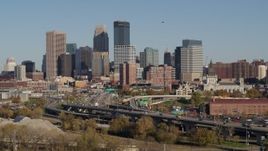5.7K aerial stock footage ascend from trees for view of the city skyline, Downtown Minneapolis, Minnesota Aerial Stock Footage | DX0001_002174