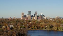 5.7K aerial stock footage of the city's skyline seen while flying by lakefront houses, Downtown Minneapolis, Minnesota Aerial Stock Footage | DX0001_002191