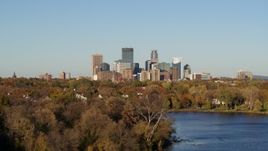 5.7K aerial stock footage of the city's skyline seen while passing by lakefront houses, Downtown Minneapolis, Minnesota Aerial Stock Footage | DX0001_002192
