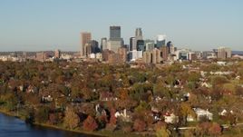 5.7K aerial stock footage a wide view of the city's skyline seen from homes by the lake, Downtown Minneapolis, Minnesota Aerial Stock Footage | DX0001_002195