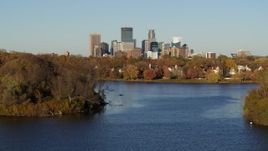 5.7K aerial stock footage of the downtown skyline seen from homes by Lake of the Isles, Downtown Minneapolis, Minnesota Aerial Stock Footage | DX0001_002201