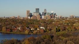 5.7K aerial stock footage ascend from Lake of the Isles to reveal homes and city skyline, Downtown Minneapolis, Minnesota Aerial Stock Footage | DX0001_002204