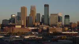 5.7K aerial stock footage of descending by the city's downtown skyline at sunset in Downtown Minneapolis, Minnesota Aerial Stock Footage | DX0001_002220