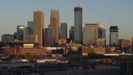 5.7K aerial stock footage ascend and approach the city's downtown skyline at sunset, Downtown Minneapolis, Minnesota Aerial Stock Footage | DX0001_002229