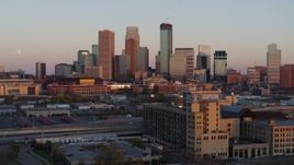 5.7K aerial stock footage flyby the city's skyline at sunset during ascent, Downtown Minneapolis, Minnesota Aerial Stock Footage | DX0001_002236