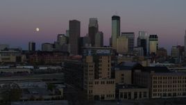 5.7K aerial stock footage flying by the city's downtown skyline at twilight, reveal moon and market, Downtown Minneapolis, Minnesota Aerial Stock Footage | DX0001_002251