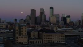 5.7K aerial stock footage passing by the city's downtown skyline at twilight, reveal moon and market, Downtown Minneapolis, Minnesota Aerial Stock Footage | DX0001_002252