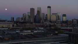 5.7K aerial stock footage of the moon near the city's downtown skyline at twilight, Downtown Minneapolis, Minnesota Aerial Stock Footage | DX0001_002256