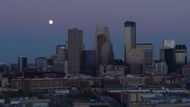 5.7K aerial stock footage ascend with view of moon near the city's downtown skyline at twilight, Downtown Minneapolis, Minnesota Aerial Stock Footage | DX0001_002259