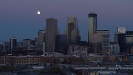 5.7K aerial stock footage of moon above the city's downtown skyline at twilight, Downtown Minneapolis, Minnesota Aerial Stock Footage | DX0001_002260