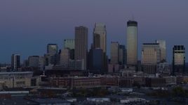 5.7K aerial stock footage of flying by the city's skyline before ascent at twilight, Downtown Minneapolis, Minnesota Aerial Stock Footage | DX0001_002261