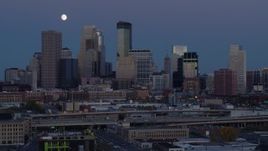 5.7K aerial stock footage flyby the city's skyline with the moon in the sky at twilight, Downtown Minneapolis, Minnesota Aerial Stock Footage | DX0001_002265