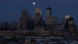 5.7K aerial stock footage of the moon above skyscrapers in city skyline at twilight, Downtown Minneapolis, Minnesota Aerial Stock Footage | DX0001_002273