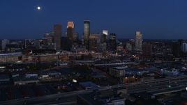 5.7K aerial stock footage of a view of the moon above city skyline at twilight, Downtown Minneapolis, Minnesota Aerial Stock Footage | DX0001_002278