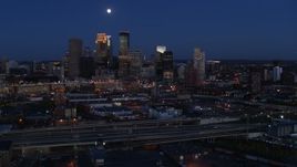 5.7K aerial stock footage of a view of the moon above city's downtown skyline at twilight, Downtown Minneapolis, Minnesota Aerial Stock Footage | DX0001_002279