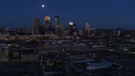 5.7K aerial stock footage fly away from the moon above city's downtown skyline at twilight, Downtown Minneapolis, Minnesota Aerial Stock Footage | DX0001_002280