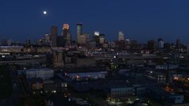 5.7K aerial stock footage flying by the moon above city's downtown skyline at twilight, Downtown Minneapolis, Minnesota Aerial Stock Footage | DX0001_002281