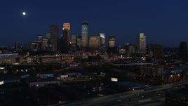 5.7K aerial stock footage descend with view of moon above city's skyline at twilight, Downtown Minneapolis, Minnesota Aerial Stock Footage | DX0001_002284