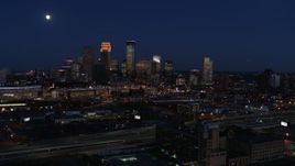 5.7K aerial stock footage descend with view of moon above city's skyline at twilight, Downtown Minneapolis, Minnesota Aerial Stock Footage | DX0001_002286