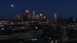 5.7K aerial stock footage ascend to approach moon above city's skyline at twilight, Downtown Minneapolis, Minnesota Aerial Stock Footage | DX0001_002287