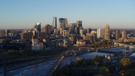 5.7K aerial stock footage flyby bridge with the city skyline across the river at sunrise, Downtown Minneapolis, Minnesota Aerial Stock Footage | DX0001_002291