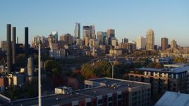5.7K aerial stock footage of a view of the city skyline across the river at sunrise, Downtown Minneapolis, Minnesota Aerial Stock Footage | DX0001_002293