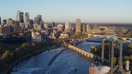 5.7K aerial stock footage flying bridge and river with view of skyline at sunrise, Downtown Minneapolis, Minnesota Aerial Stock Footage | DX0001_002299