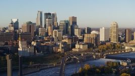 5.7K aerial stock footage of a view of the city skyline across the Mississippi River at sunrise, Downtown Minneapolis, Minnesota Aerial Stock Footage | DX0001_002304