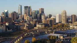 5.7K aerial stock footage passing the city skyline seen from across the river at sunrise, Downtown Minneapolis, Minnesota Aerial Stock Footage | DX0001_002309